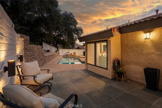 23726 La Salle Canyon Rd, Newhall, CA 91321 - patio terrace at dusk with a patio area and a fenced backyard