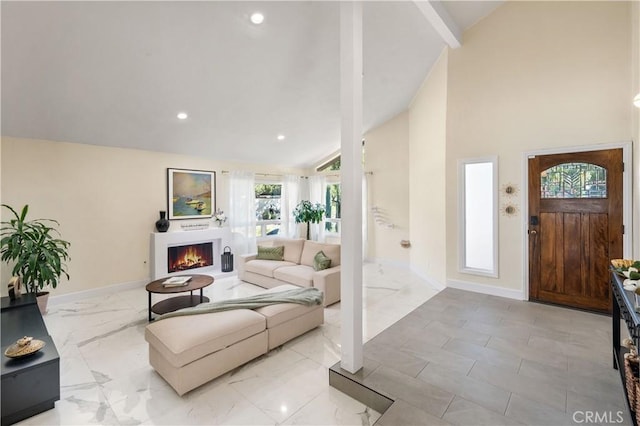 living area featuring a warm lit fireplace, high vaulted ceiling, recessed lighting, baseboards, and marble finish floor