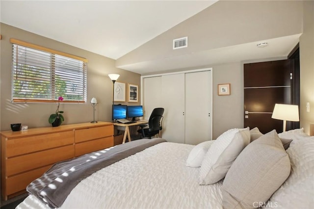 bedroom featuring vaulted ceiling and a closet