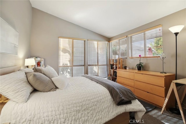 carpeted bedroom featuring lofted ceiling