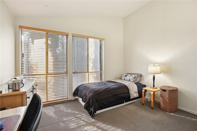 bedroom featuring lofted ceiling and carpet floors