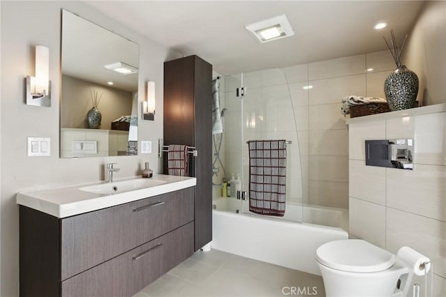 full bathroom featuring tiled shower / bath combo, vanity, tile patterned flooring, and toilet