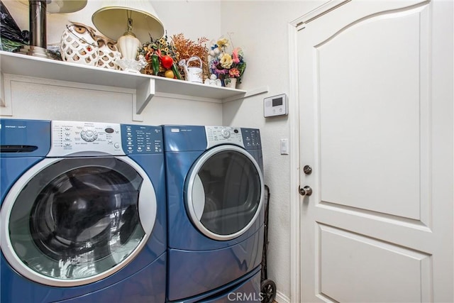 clothes washing area featuring washer and dryer