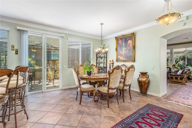 tiled dining room featuring ornamental molding and a chandelier