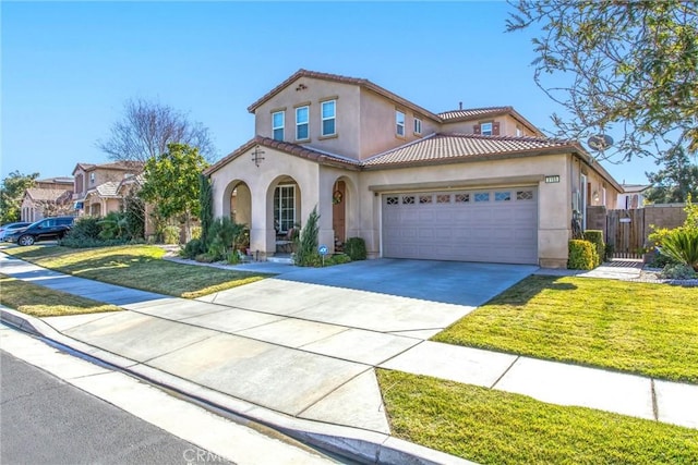 mediterranean / spanish home with a garage and a front yard