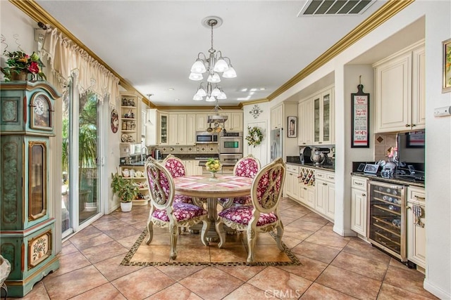 tiled dining space with wine cooler, crown molding, and an inviting chandelier