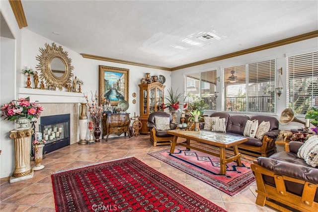 interior space with light tile patterned floors, crown molding, and a tile fireplace