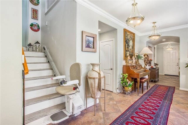 interior space with ornamental molding and light tile patterned floors