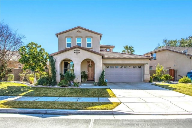 mediterranean / spanish-style home with a garage and a front yard