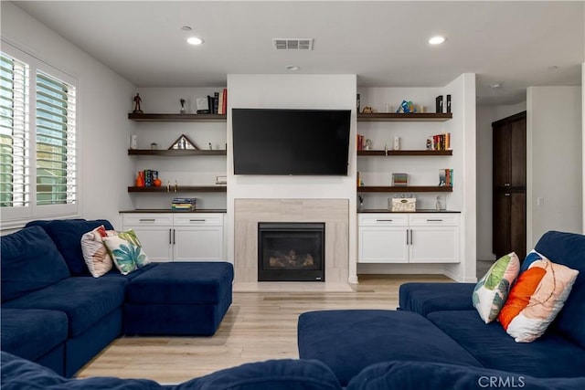 living room with a fireplace and light hardwood / wood-style floors