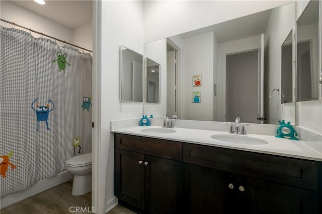 full bathroom with vanity, wood-type flooring, toilet, and shower / bathtub combination with curtain