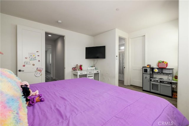 bedroom with hardwood / wood-style flooring