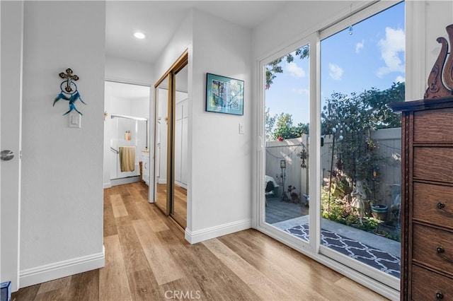 doorway with light wood-type flooring