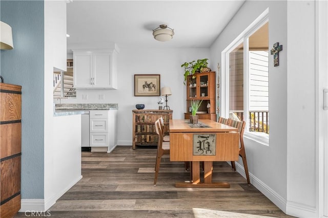 dining space with dark hardwood / wood-style flooring