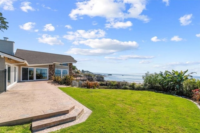 view of yard featuring a water view and a patio