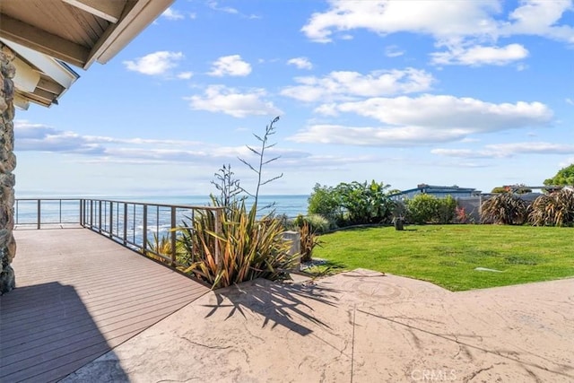 view of patio / terrace with a water view and a balcony