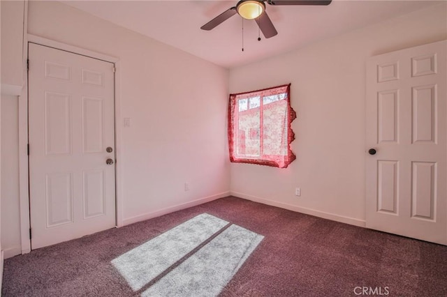 carpeted spare room featuring ceiling fan