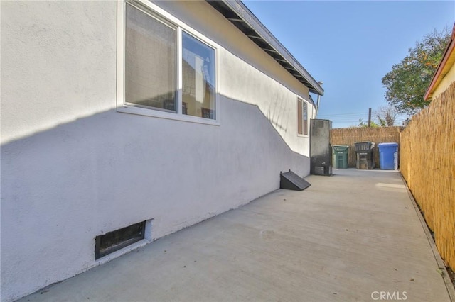 view of side of property featuring a patio area