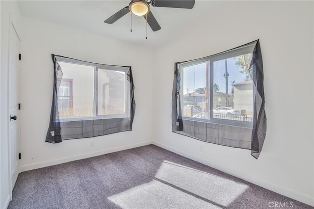 carpeted empty room featuring ceiling fan