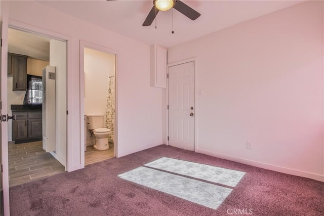 unfurnished bedroom with ensuite bath, ceiling fan, and carpet flooring