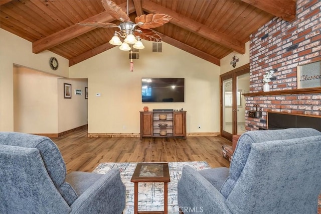 living room featuring wood ceiling, light hardwood / wood-style flooring, beamed ceiling, and ceiling fan