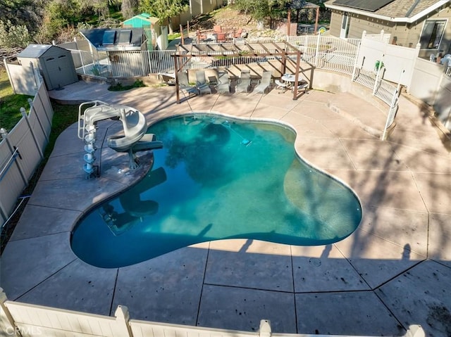 view of swimming pool featuring a water slide, a pergola, and a patio