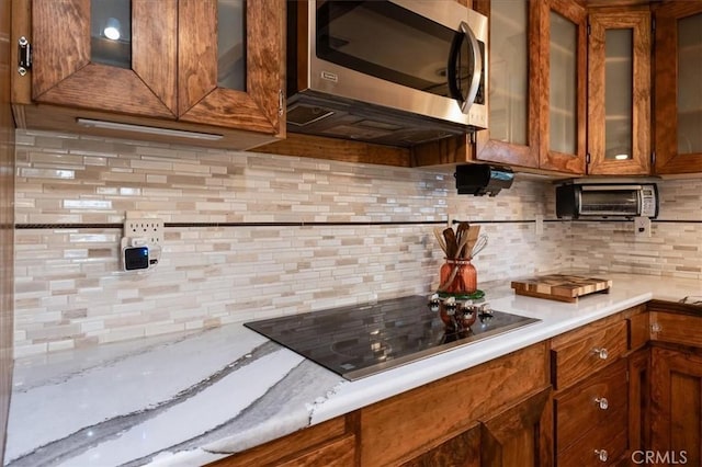 kitchen with tasteful backsplash and black electric cooktop