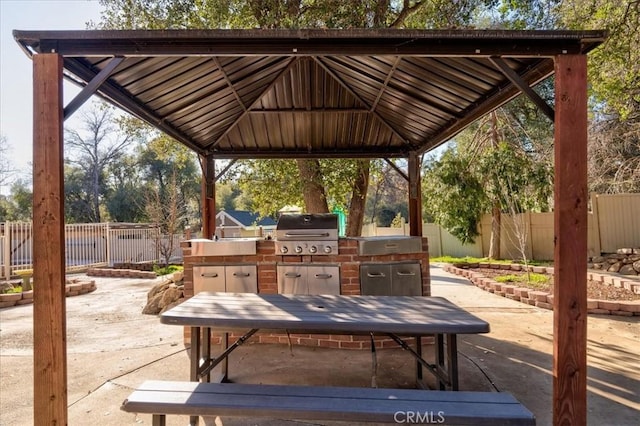 view of patio featuring area for grilling, a gazebo, and an outdoor kitchen