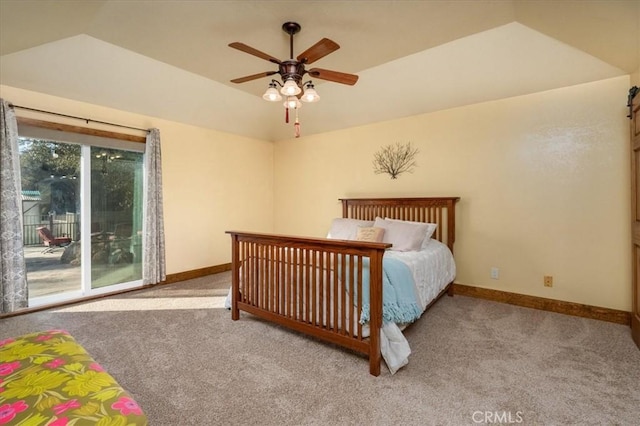 bedroom featuring ceiling fan, a tray ceiling, access to exterior, and light carpet