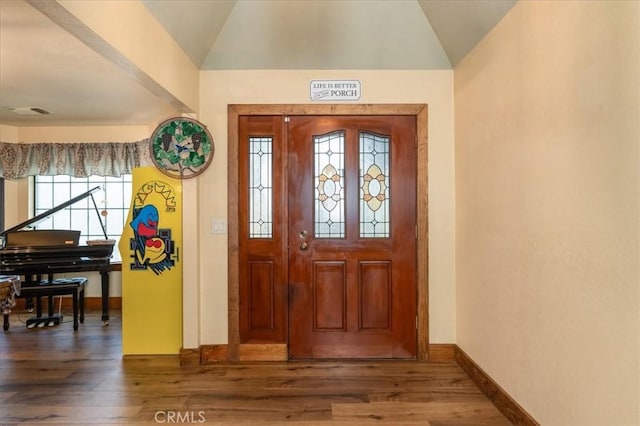 foyer featuring lofted ceiling and dark hardwood / wood-style flooring