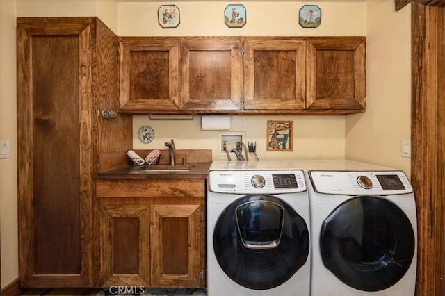 laundry area with cabinets, sink, and washing machine and dryer