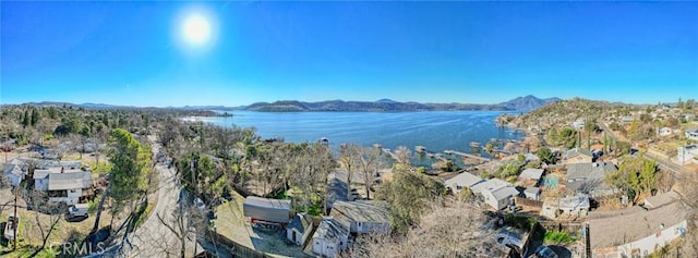 birds eye view of property with a water and mountain view