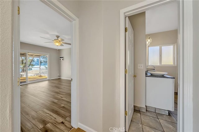 hallway featuring sink and a wealth of natural light