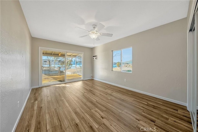 unfurnished room featuring ceiling fan and light hardwood / wood-style floors