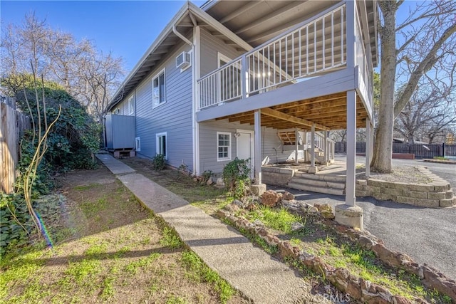 view of home's exterior featuring a wooden deck