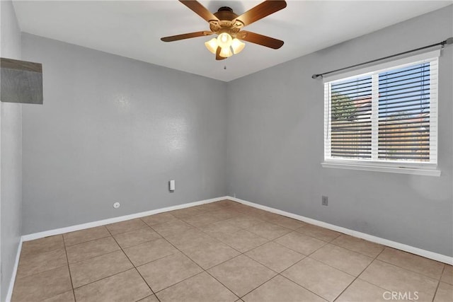 tiled empty room featuring ceiling fan