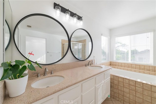 bathroom featuring vanity and separate shower and tub