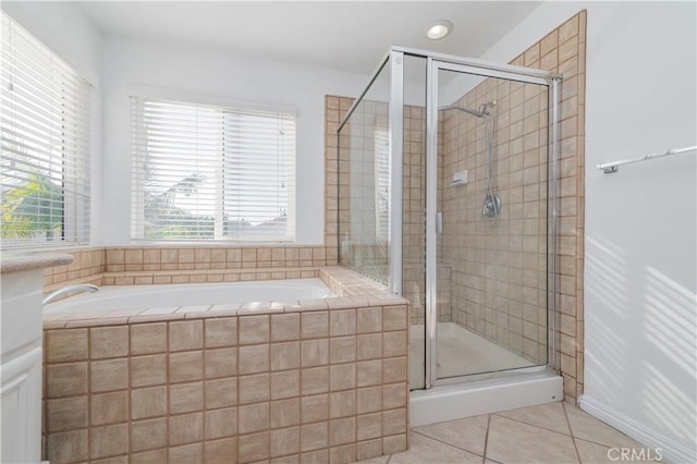 bathroom featuring tile patterned floors and shower with separate bathtub