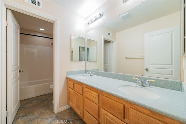 bathroom featuring tile patterned flooring, vanity, and toilet