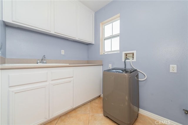 washroom featuring cabinets, washer / dryer, and light tile patterned floors