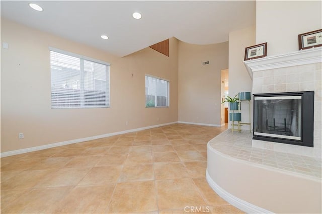 unfurnished living room featuring light tile patterned floors and a fireplace