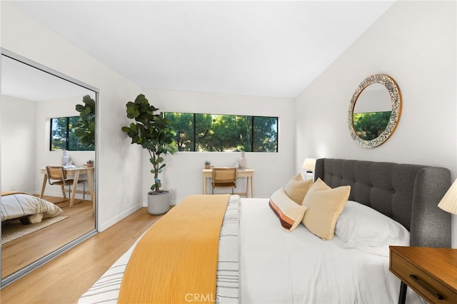 bedroom with wood-type flooring and a closet