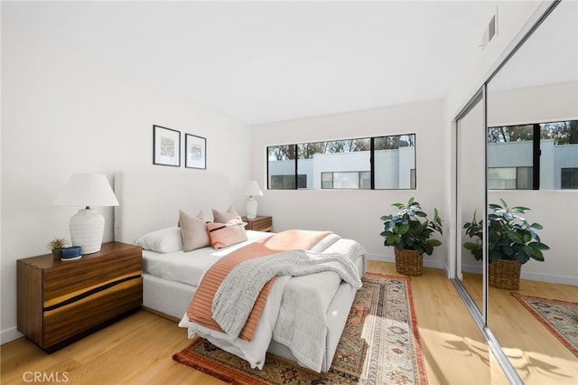 bedroom featuring light hardwood / wood-style flooring and a closet