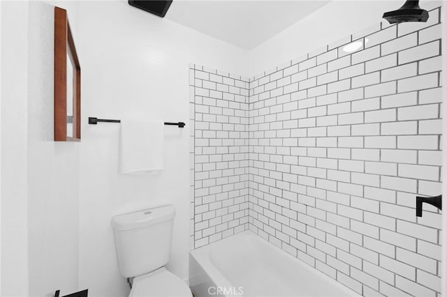 bathroom featuring tiled shower / bath and toilet