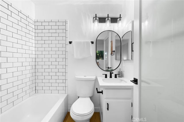 full bathroom featuring vanity, tiled shower / bath combo, and toilet