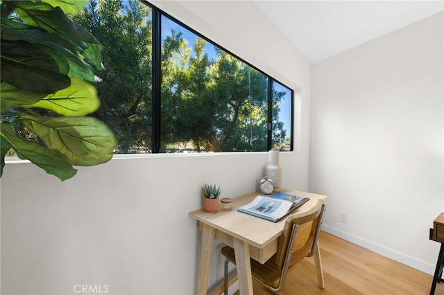 office area featuring vaulted ceiling and light hardwood / wood-style floors