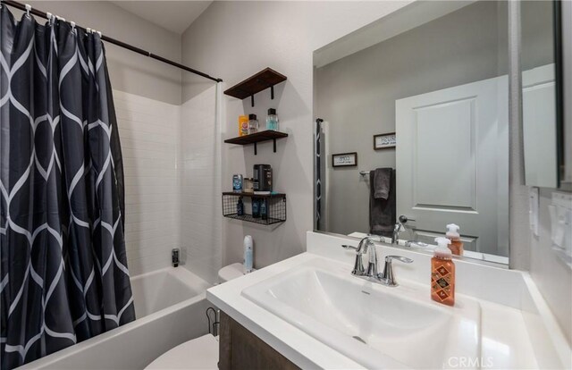 full bathroom with shower / bathtub combination with curtain, vanity, and toilet