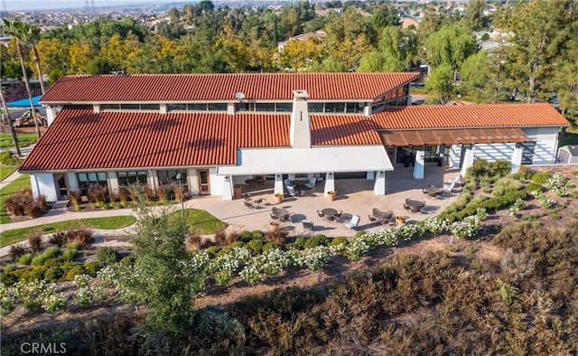 back of house featuring a patio and a tiled roof