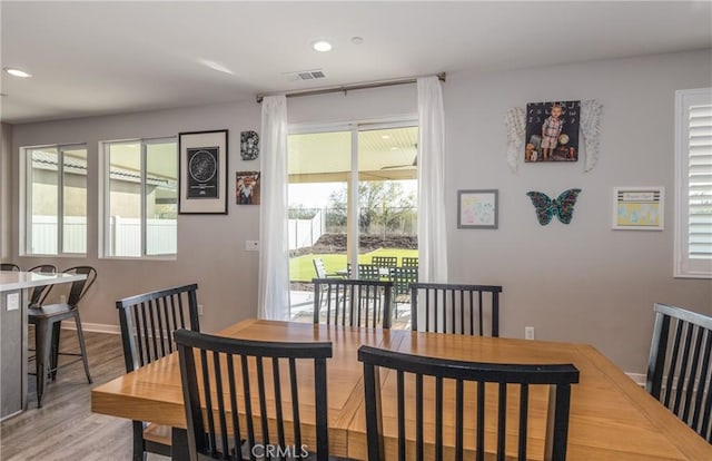 dining space with recessed lighting, visible vents, baseboards, and wood finished floors