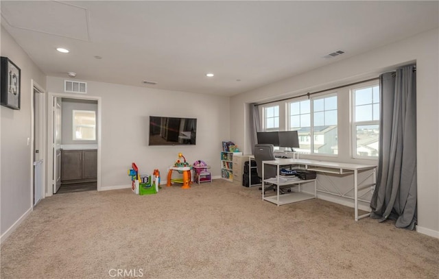 recreation room with light colored carpet